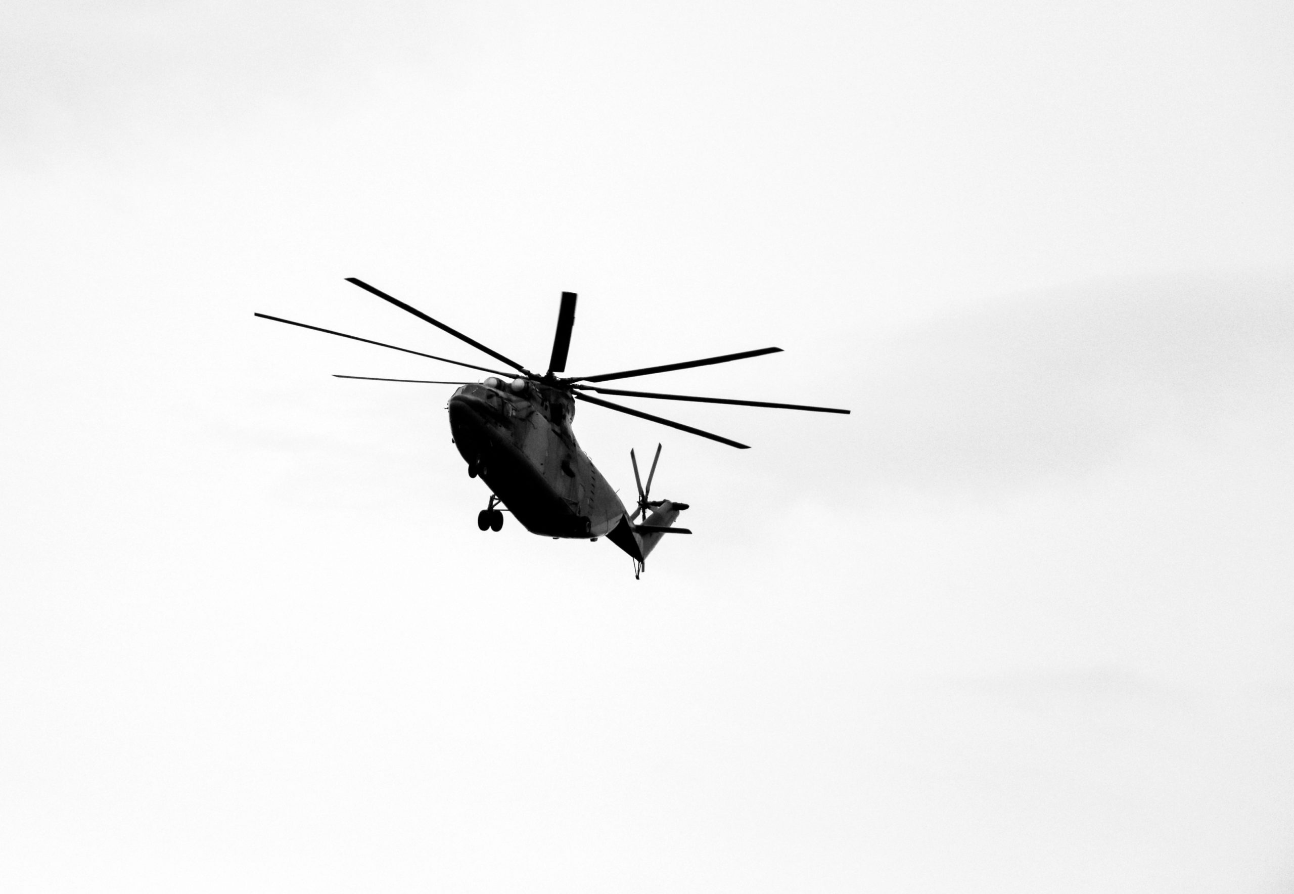 Large,Military,Helicopter,Hovers,In,Sky.,A,Camouflaged,Helicopter,Flies