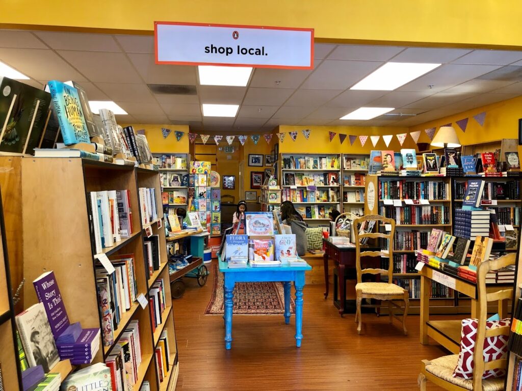 Interior of Rakestraw Books with sign that says "Shop Local"